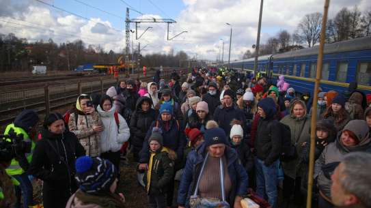 Ukrainians arrive at a Polish train station