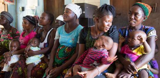 Mothers with their babies, sitting and waiting in a clinic run by Judith Lassie