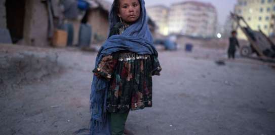 Child stands outside her home in a neighbourhood where many internally displaced people have been living for years, in Kabul, Afghanistan