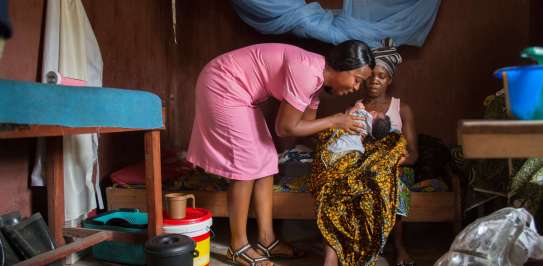 Tenneh Boweh brings her 3-month-old baby Ansumana Bangalie for a check up with Nurse Judith Lassie