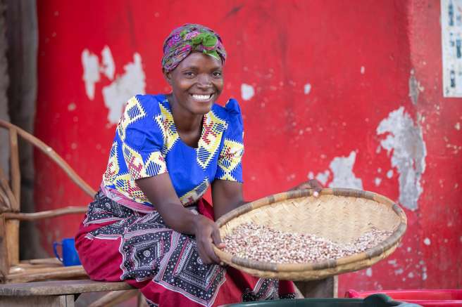 Janet Ben, 31, proudly showing the beans that she sells at the market