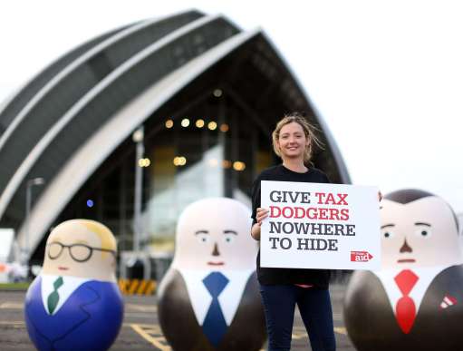 Tax campaigner standing next to some large russian dolls