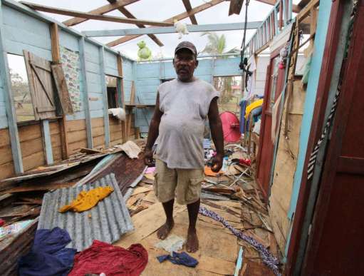 A man stands in the devastation caused by Hurricane Iota