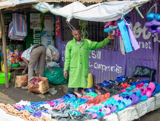 Diane pictured running her sandal business which she was able to re-open thanks to a cash grant she received from Christian Aid’s local partner CREAW.