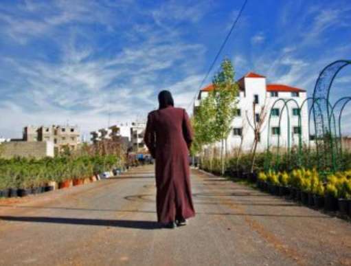 A Syrian refugee now living in Lebanon, Layan is pictured against a blue sky