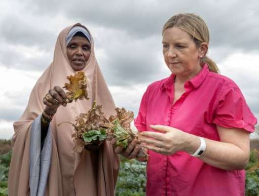 2 Women standing in field