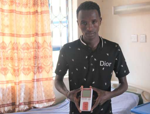 Man holding blood testing equipment