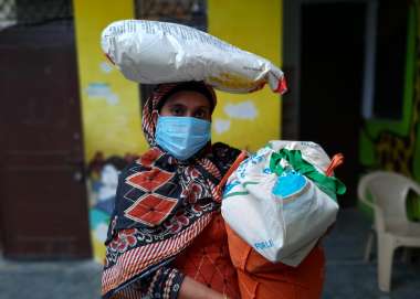 Woman receives essential food supplies for her family. 