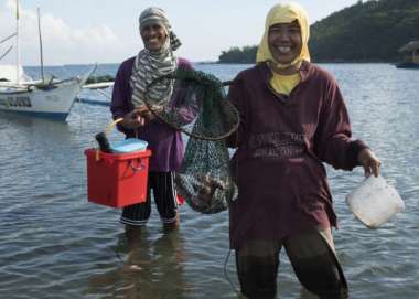 Lope and Eva fishing from their boat