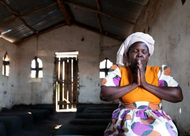 Lady eyes closed in prayer